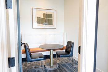 A modern room with a table and two chairs.